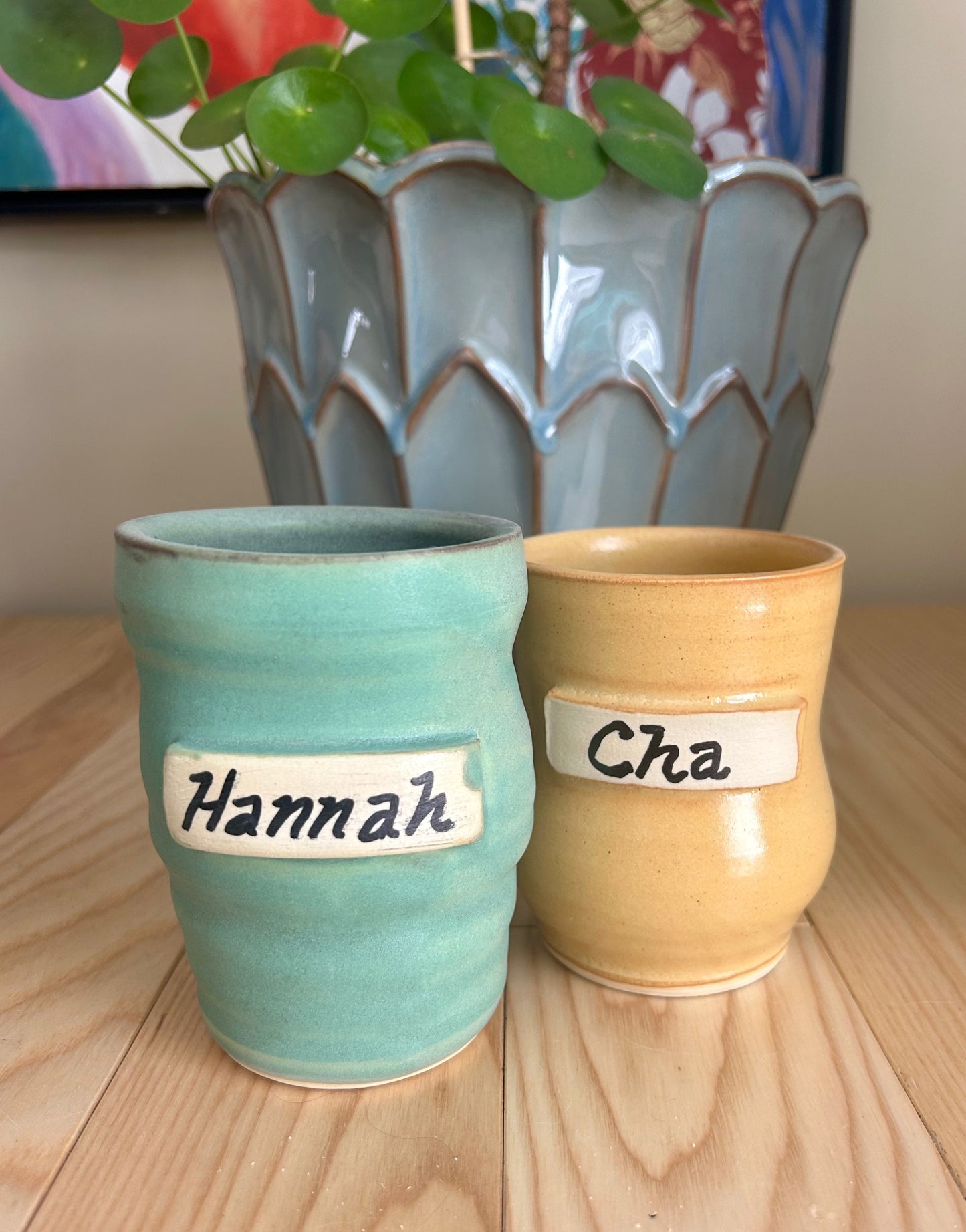 Two ceramic cups with a name plate